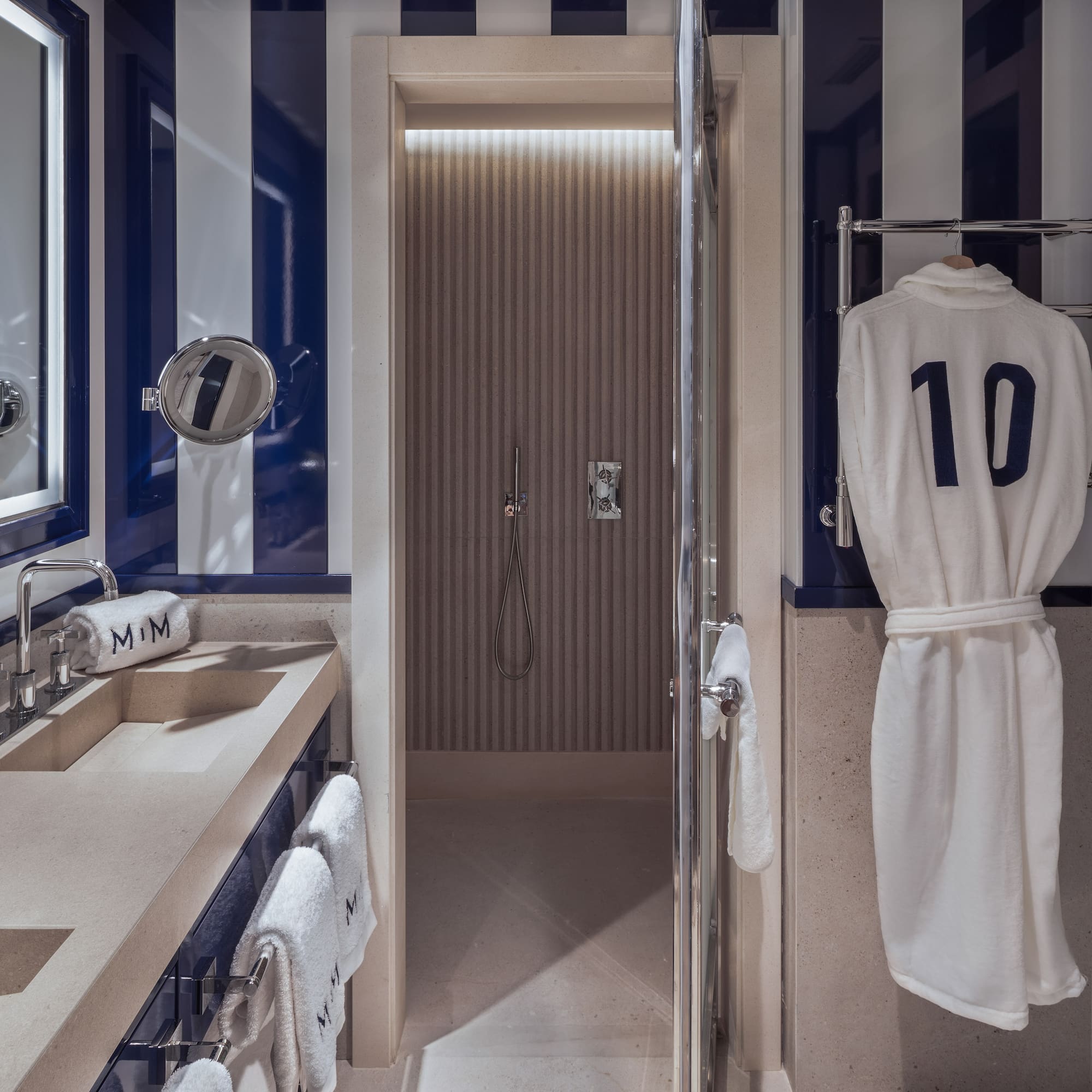 a bathroom with a towel on a swinger and a shower