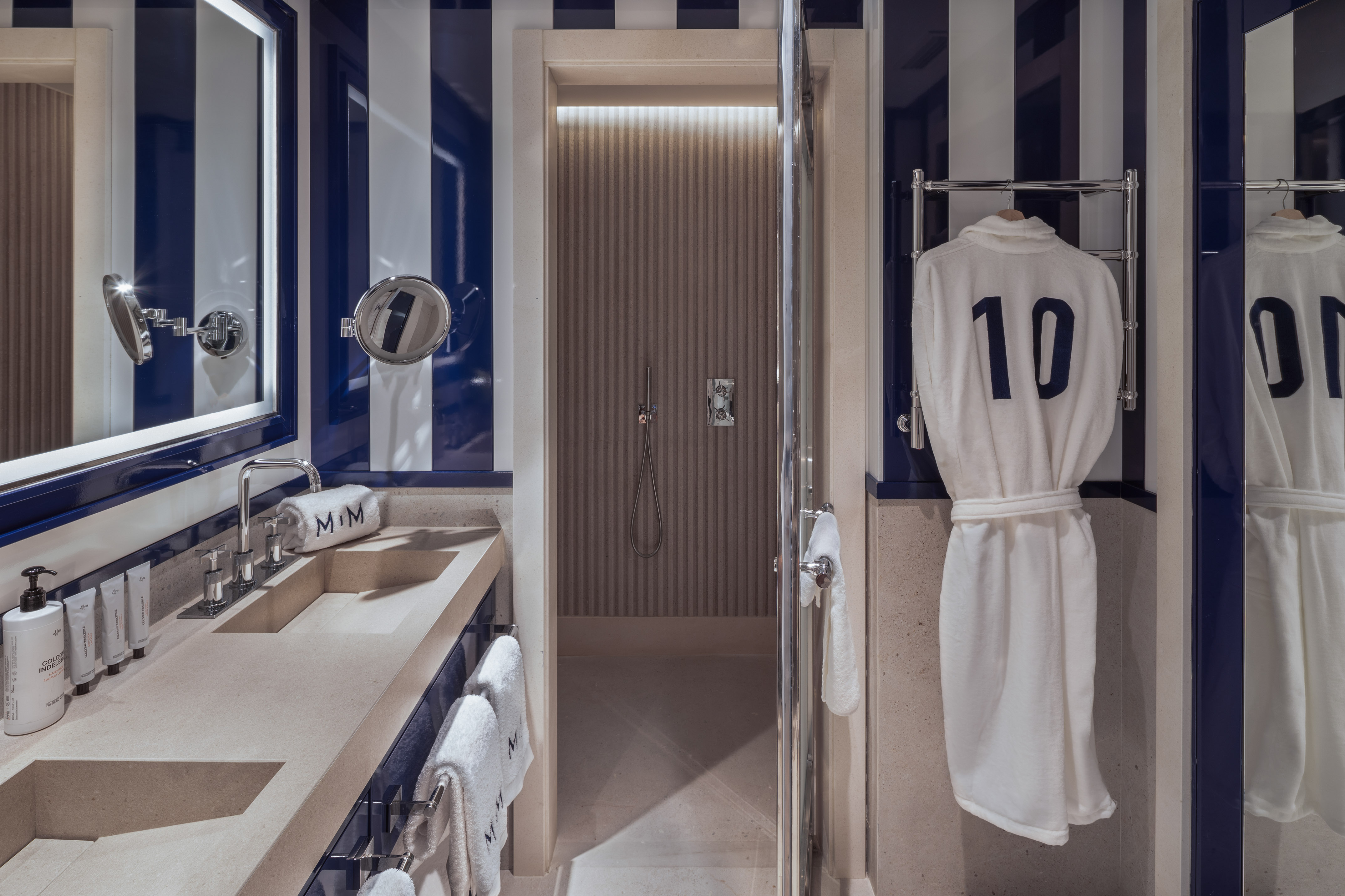 Blue & white striped hotel bathroom, double vanity, shower, '10' bathrobe.