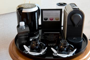 a tray with coffee machine and cups