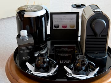 a tray with coffee machine and cups