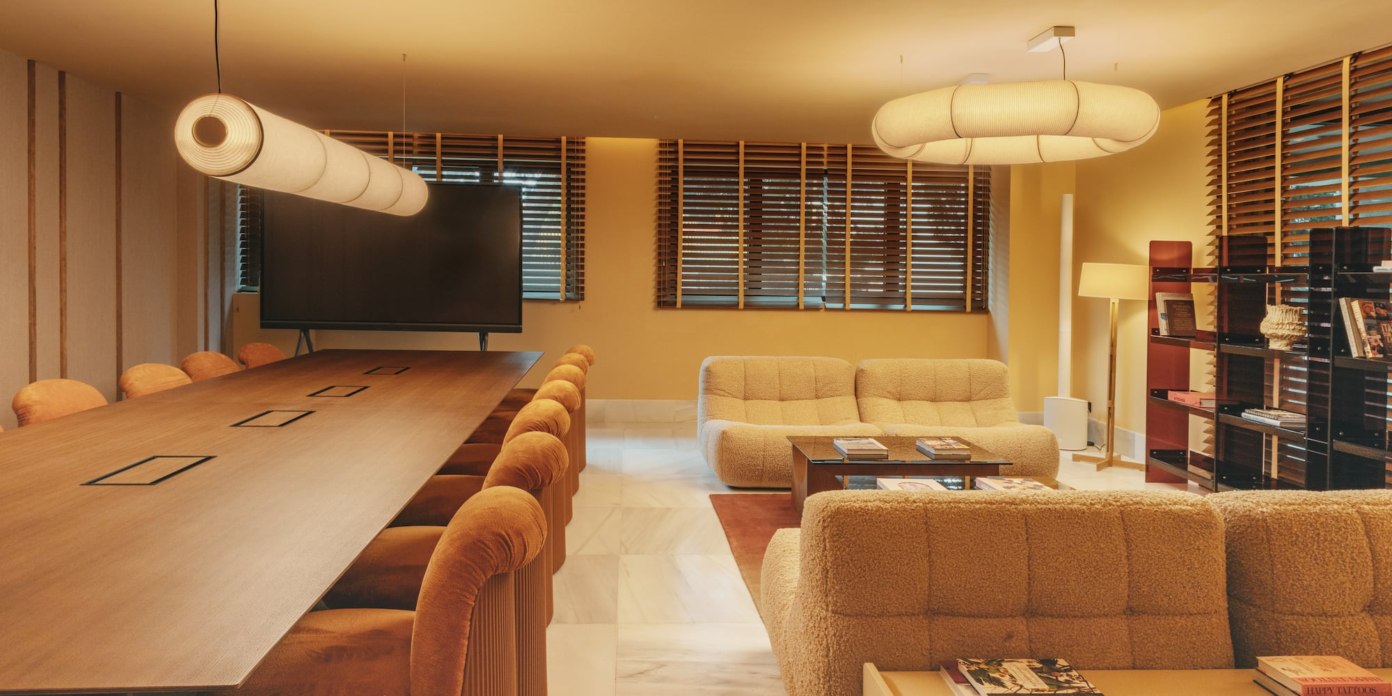 a room with a large table and couches