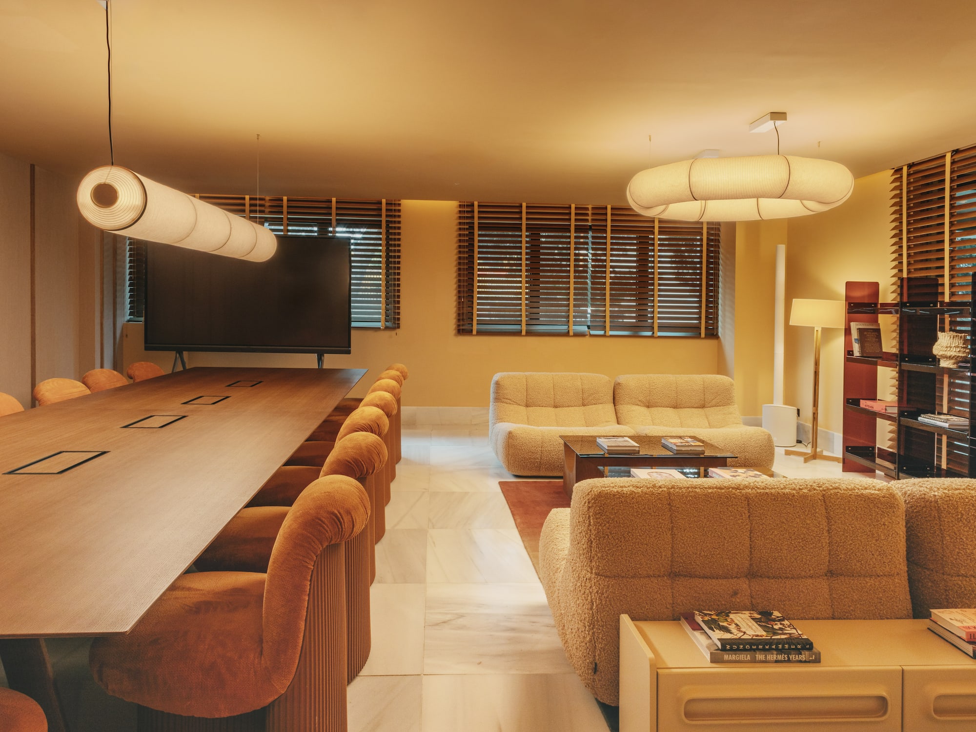 a room with a large table and couches