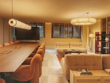 a room with a large table and couches