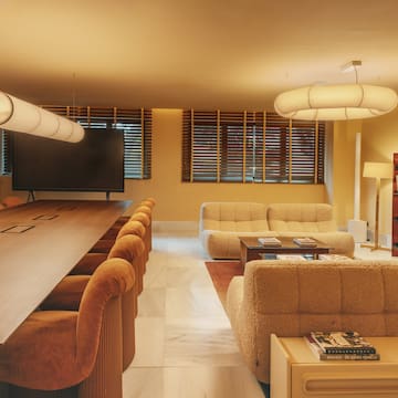 a room with a large table and couches