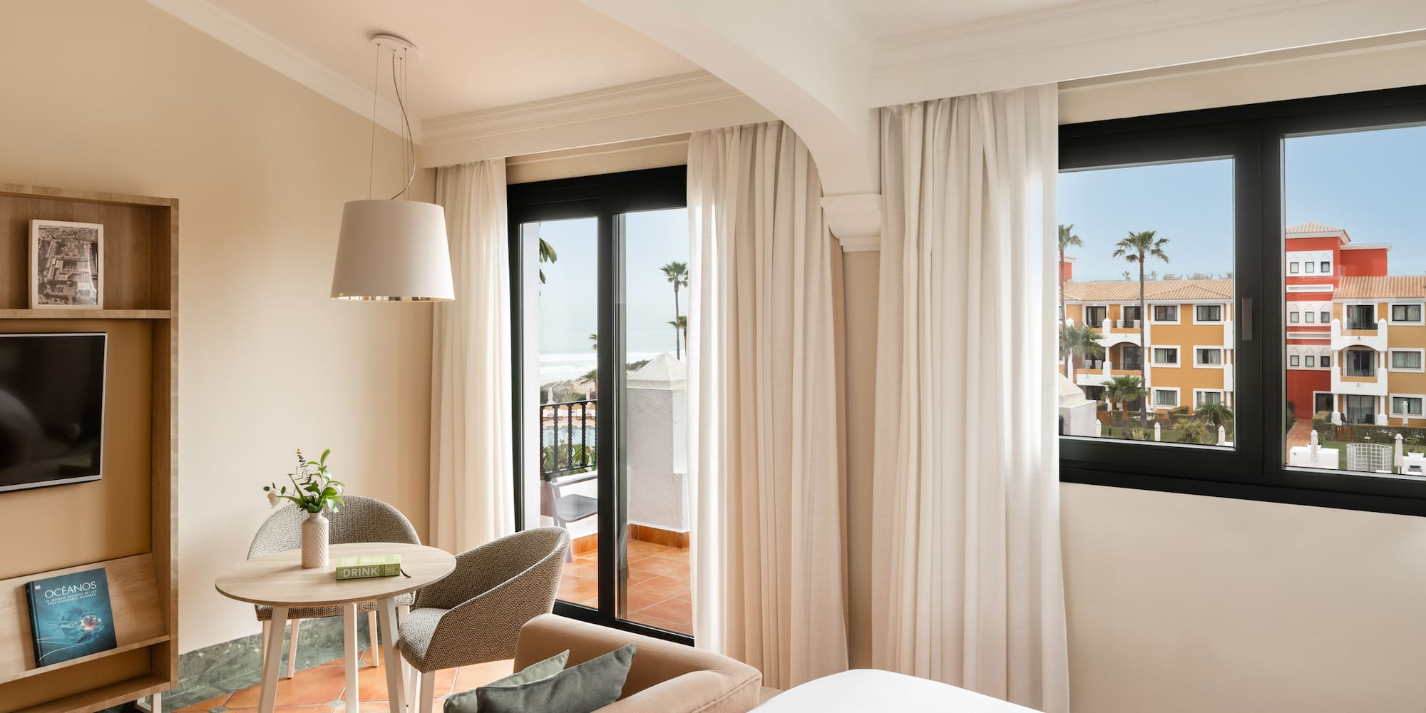 a room with a bed and a table and chairs