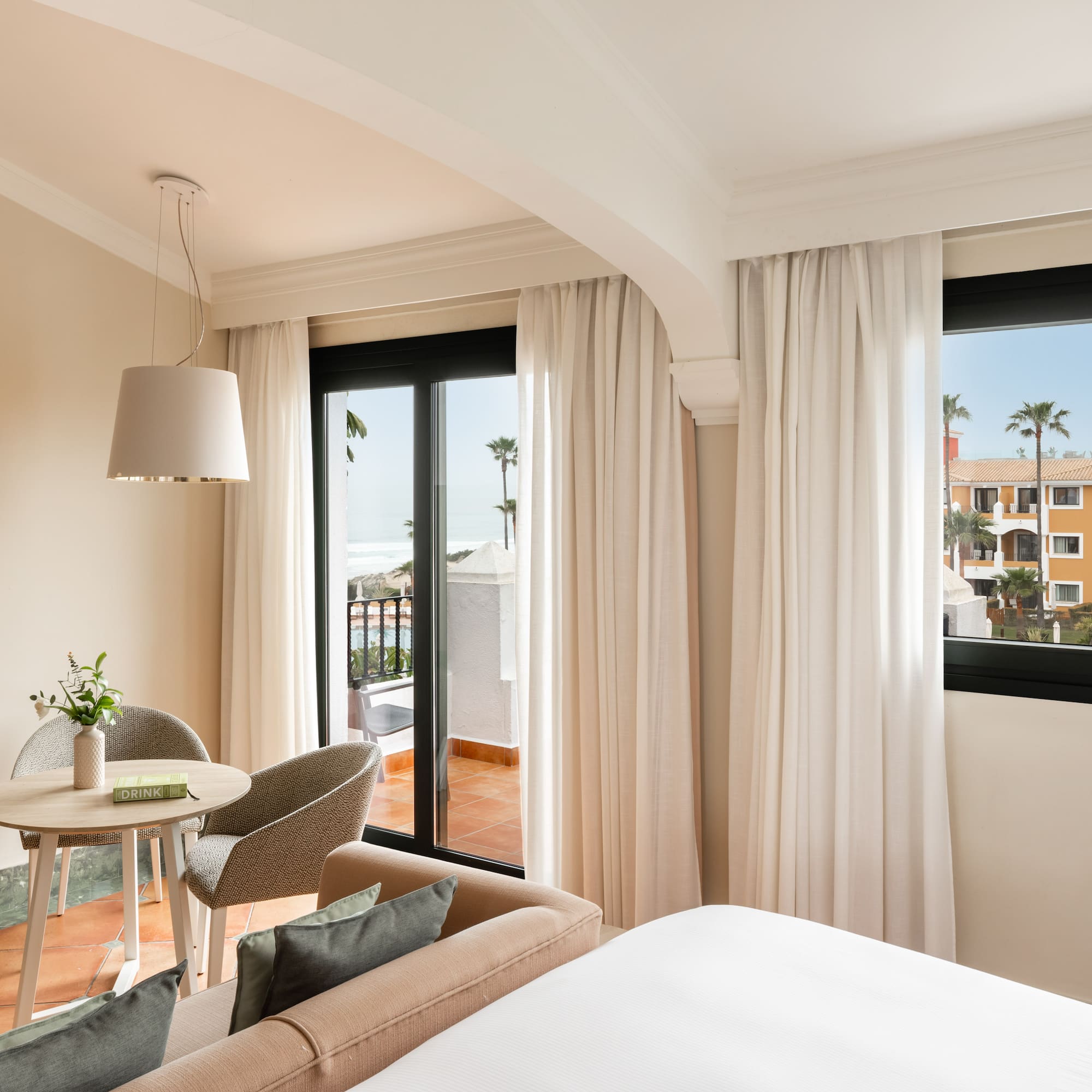 a room with a bed and a table and chairs