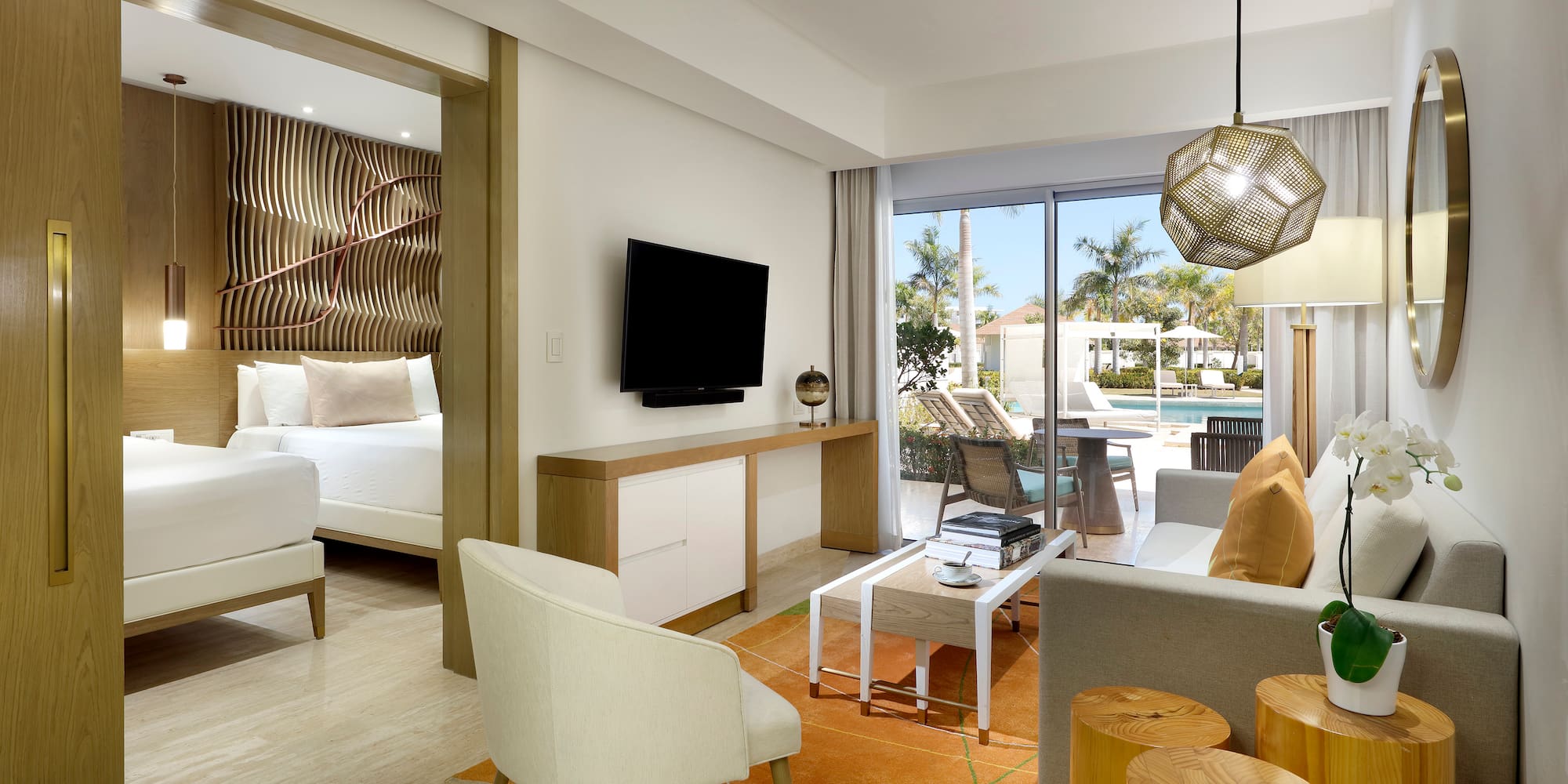 a room with a television and a pool in the background