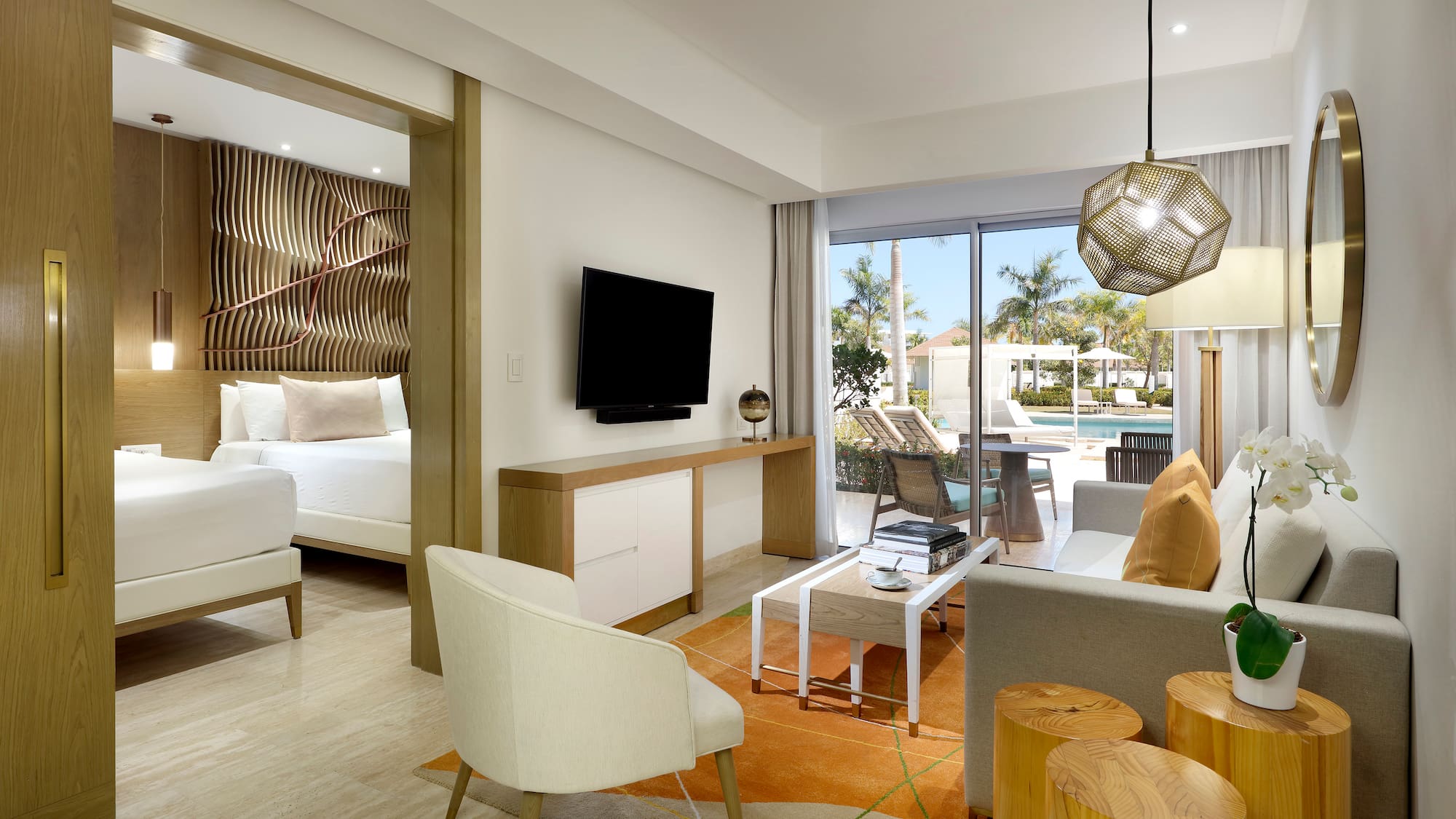 a room with a television and a pool in the background