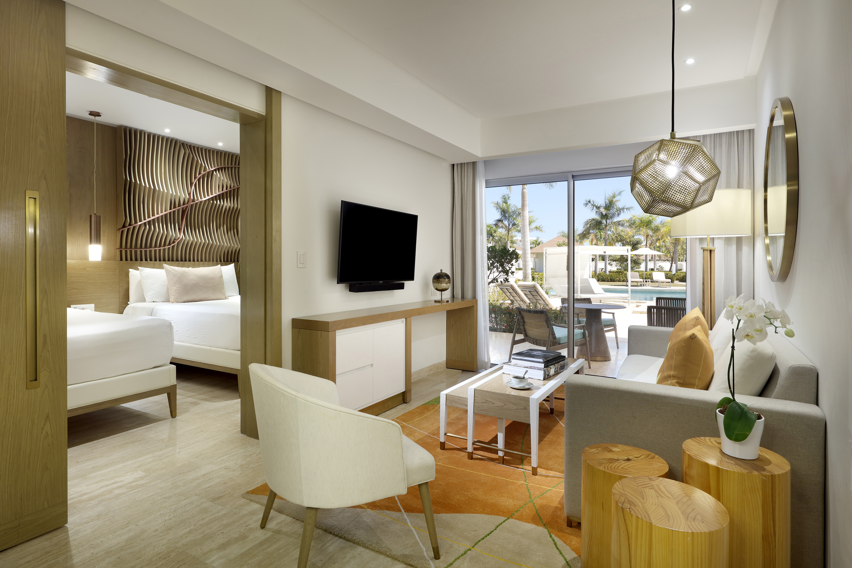 a room with a television and a pool in the background