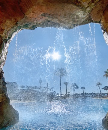 a water falling from a cave