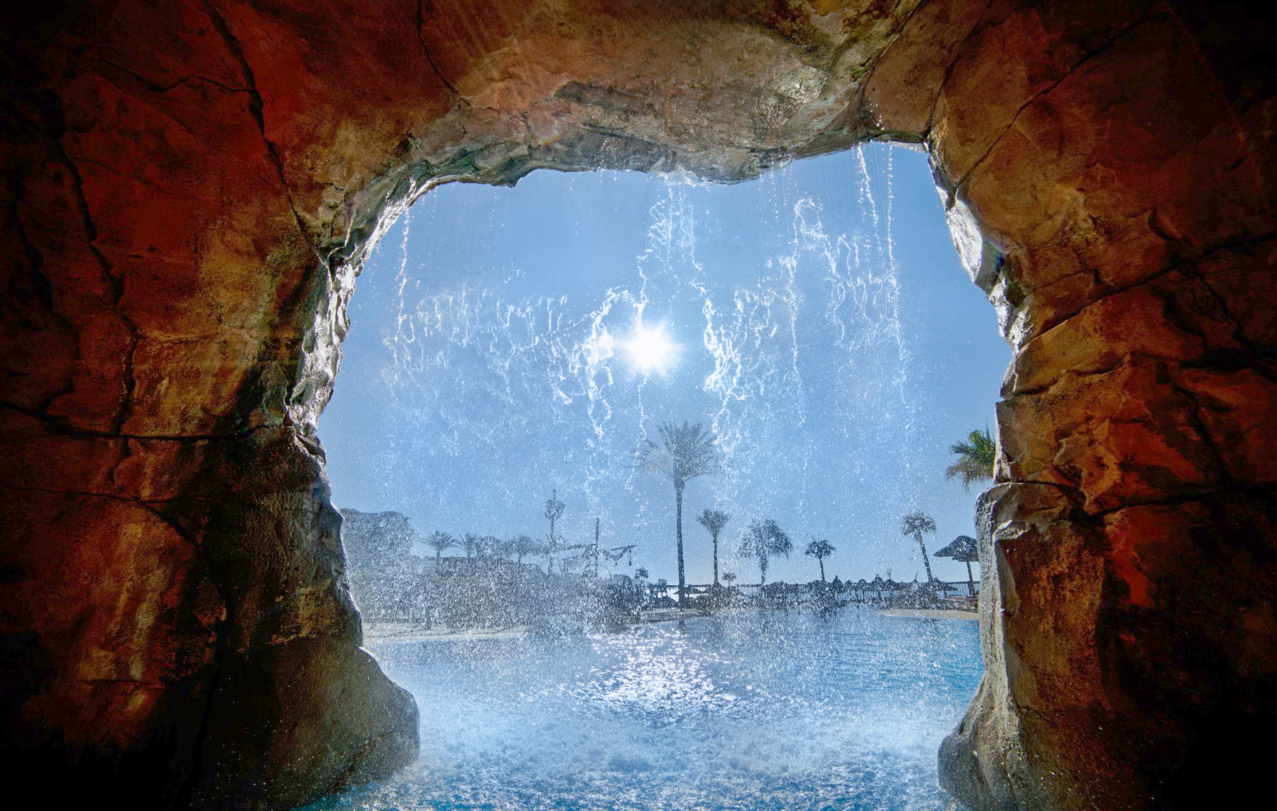 a water falling from a cave