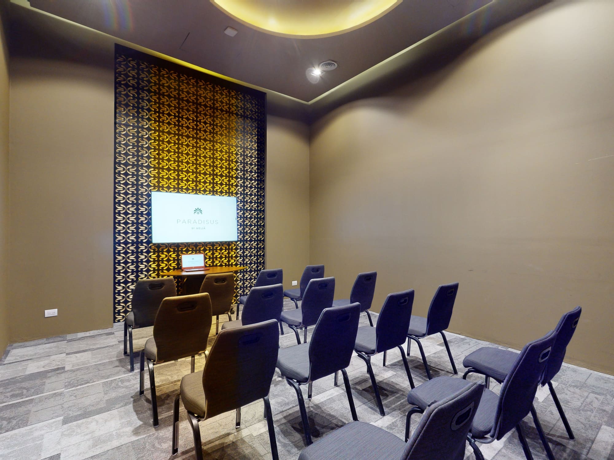 a room with chairs and a screen