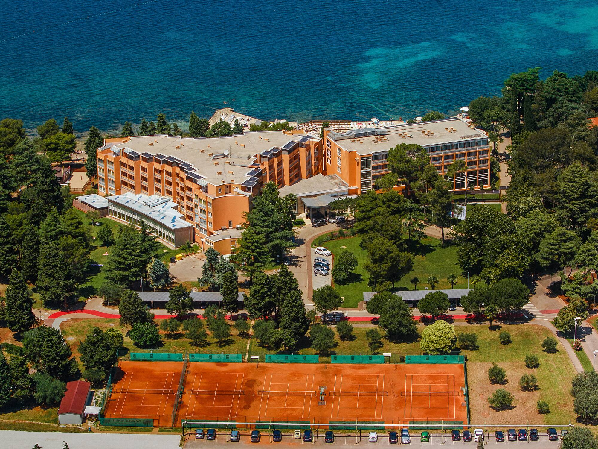 a tennis court and a building by the water