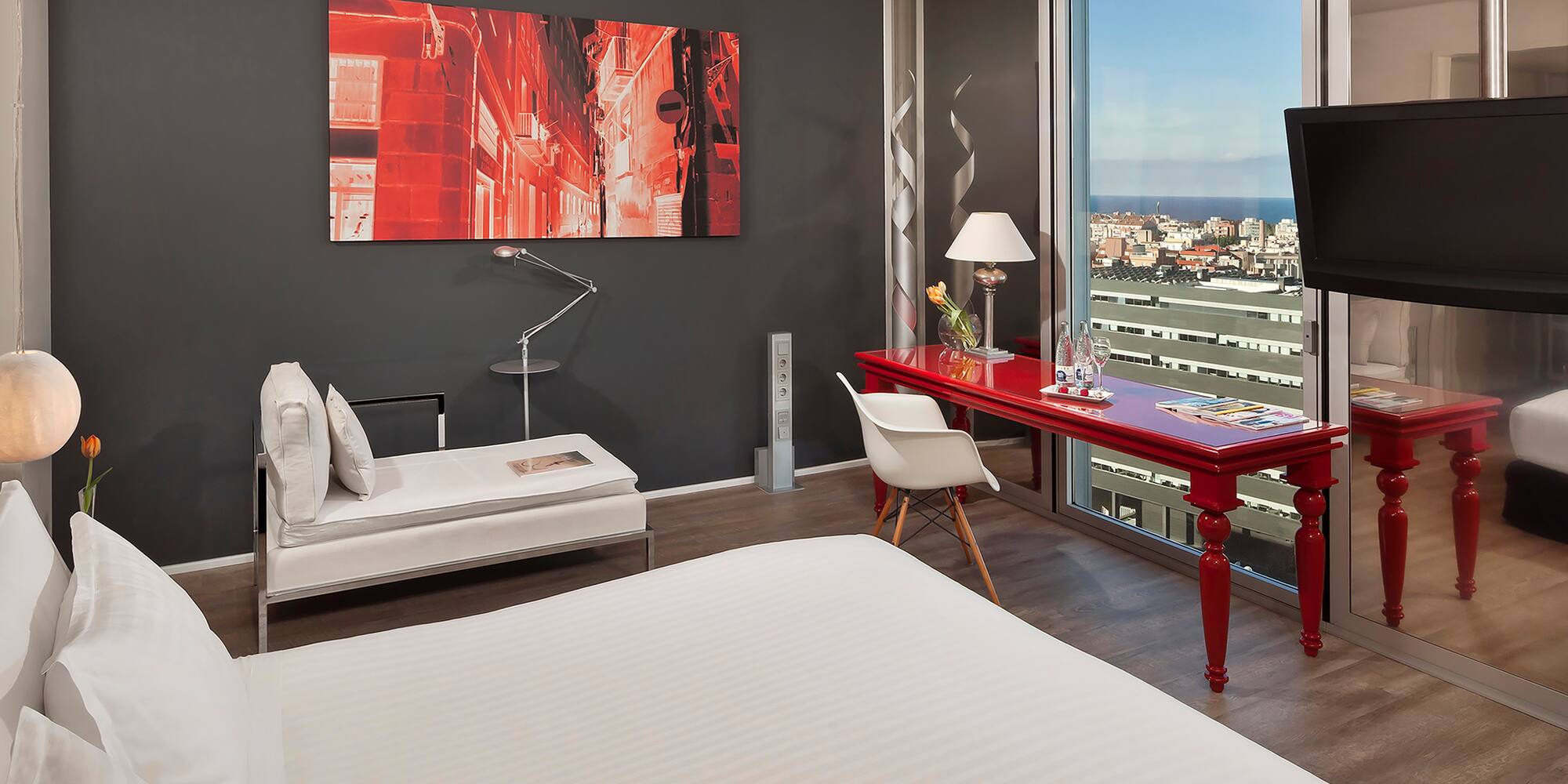 a room with a red desk and a red table