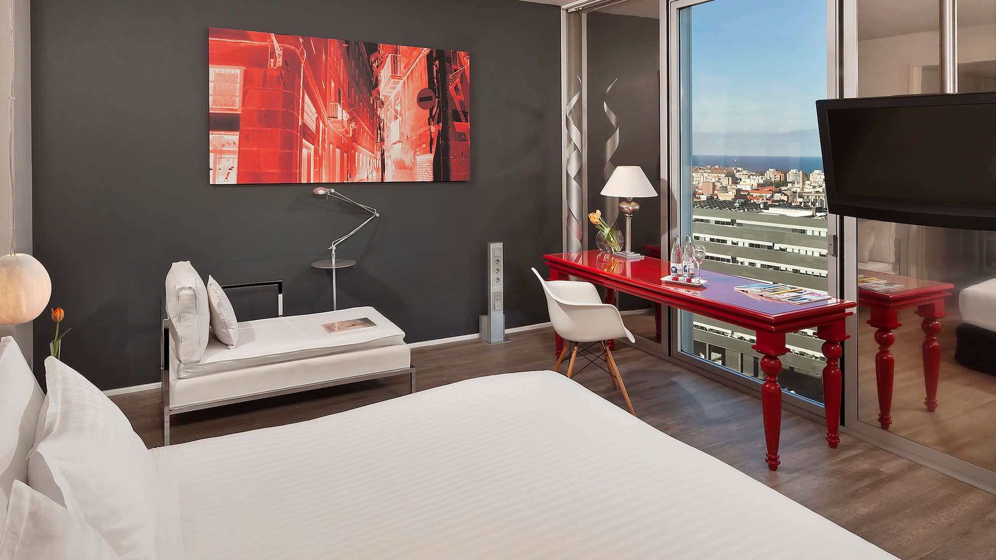 a room with a red desk and a red table