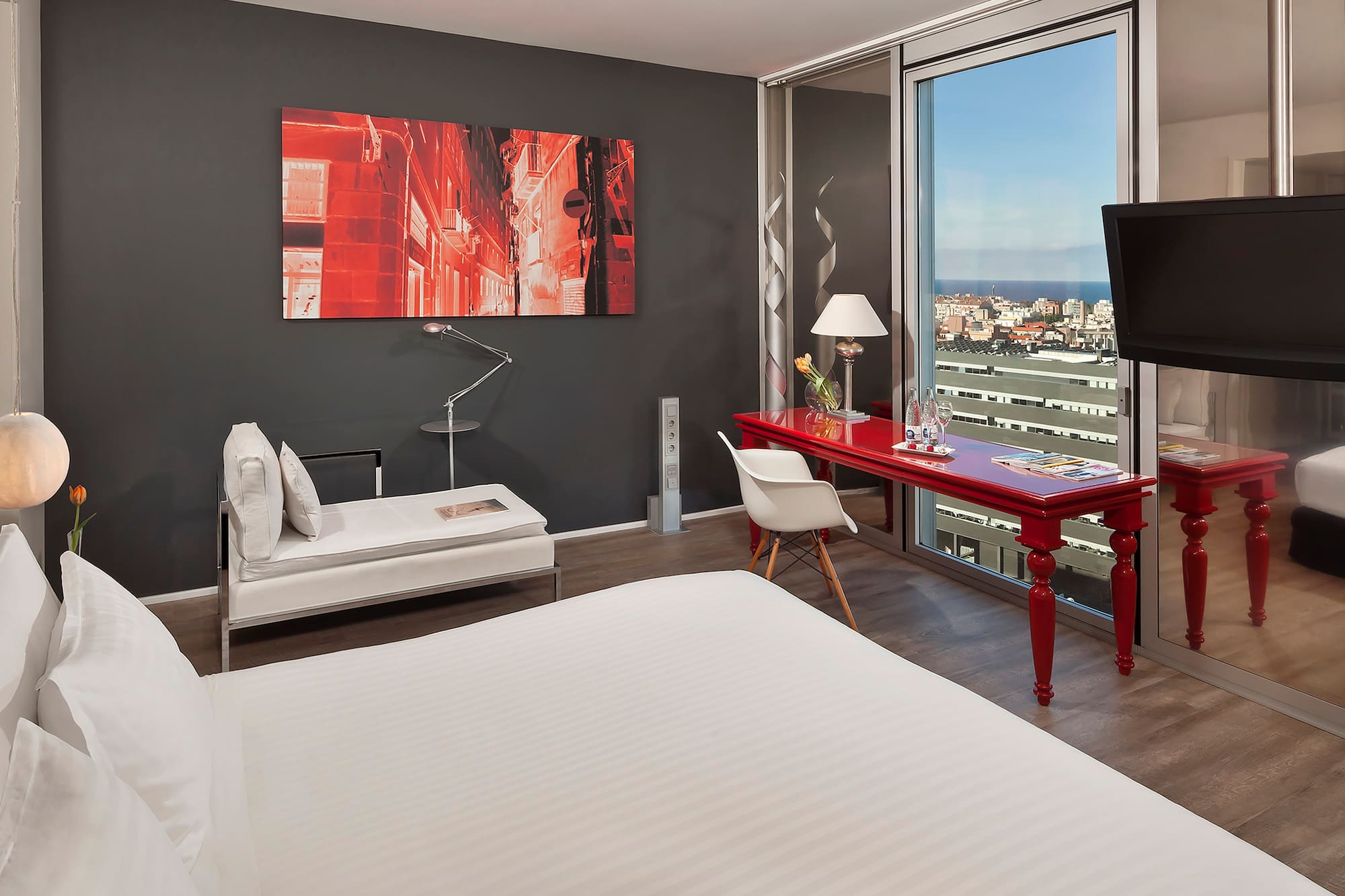 a room with a red desk and a red table