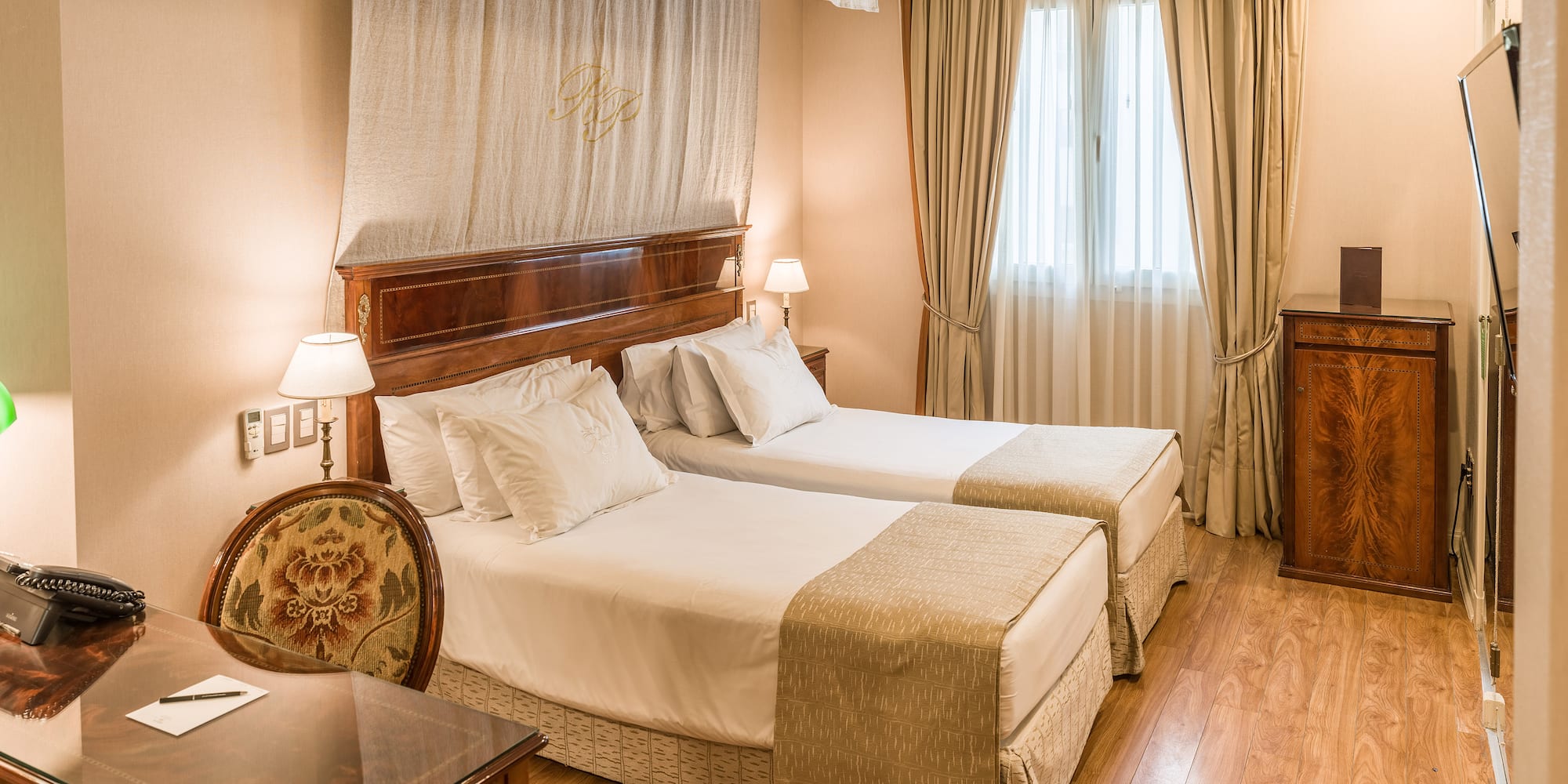 a room with two beds and a table