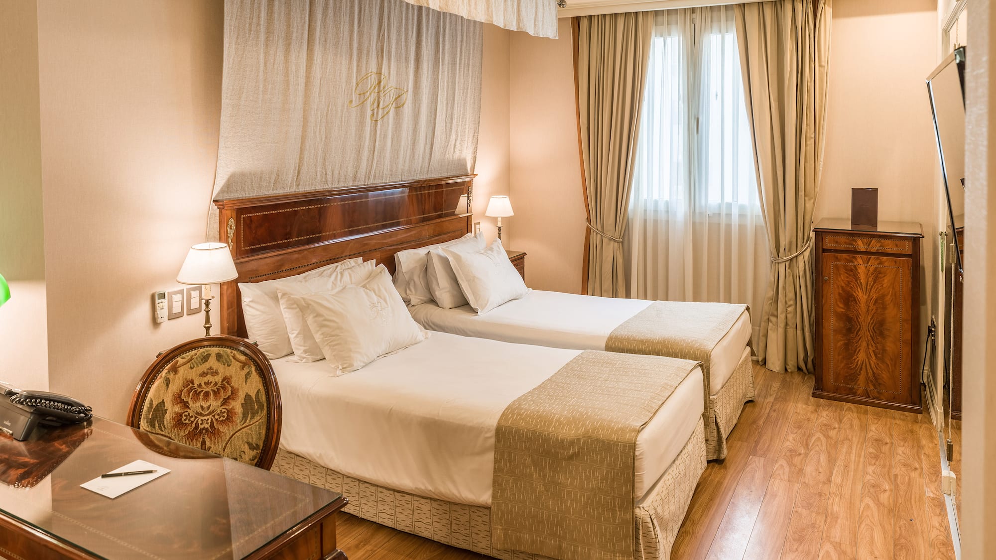 a room with two beds and a table