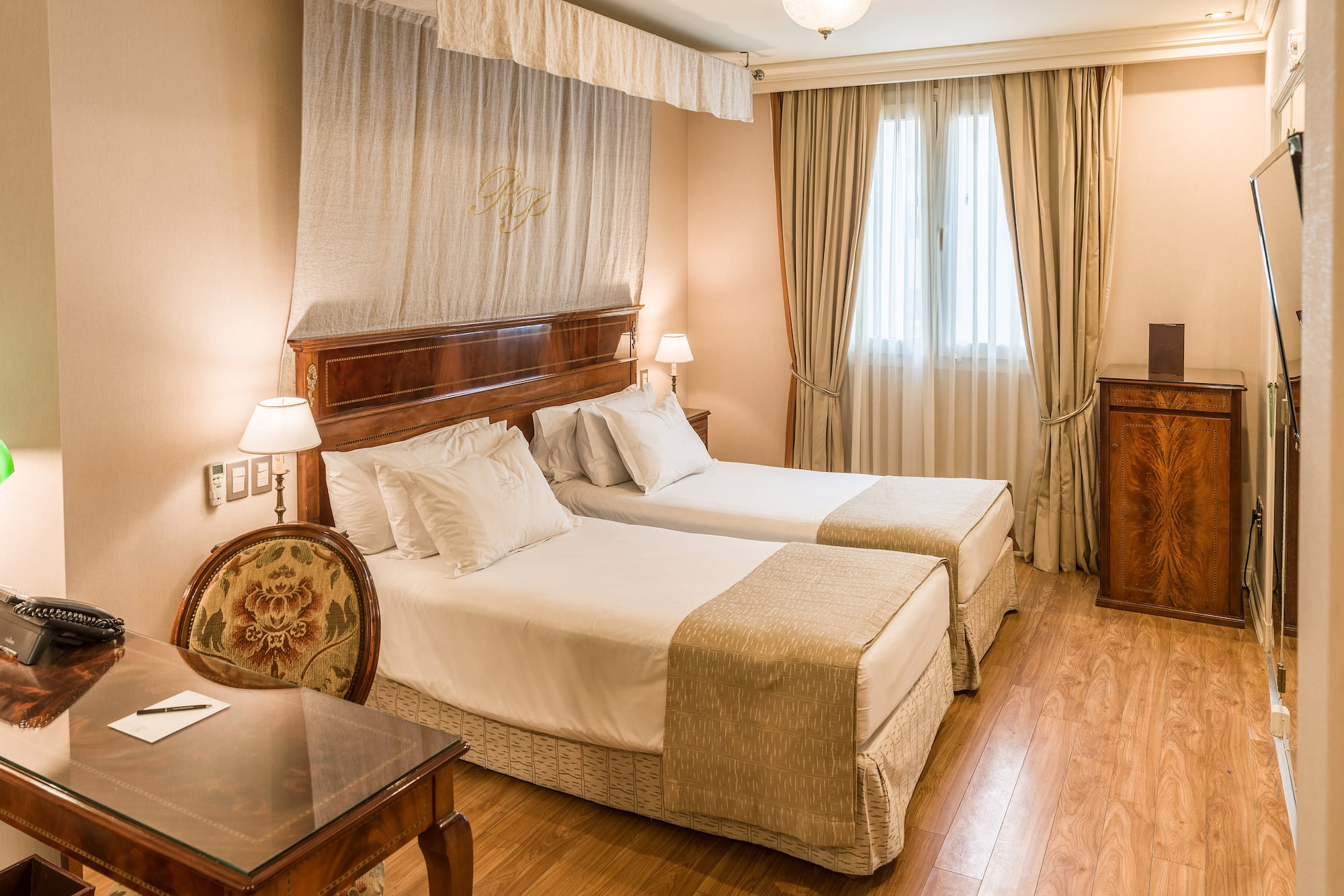 a room with two beds and a table