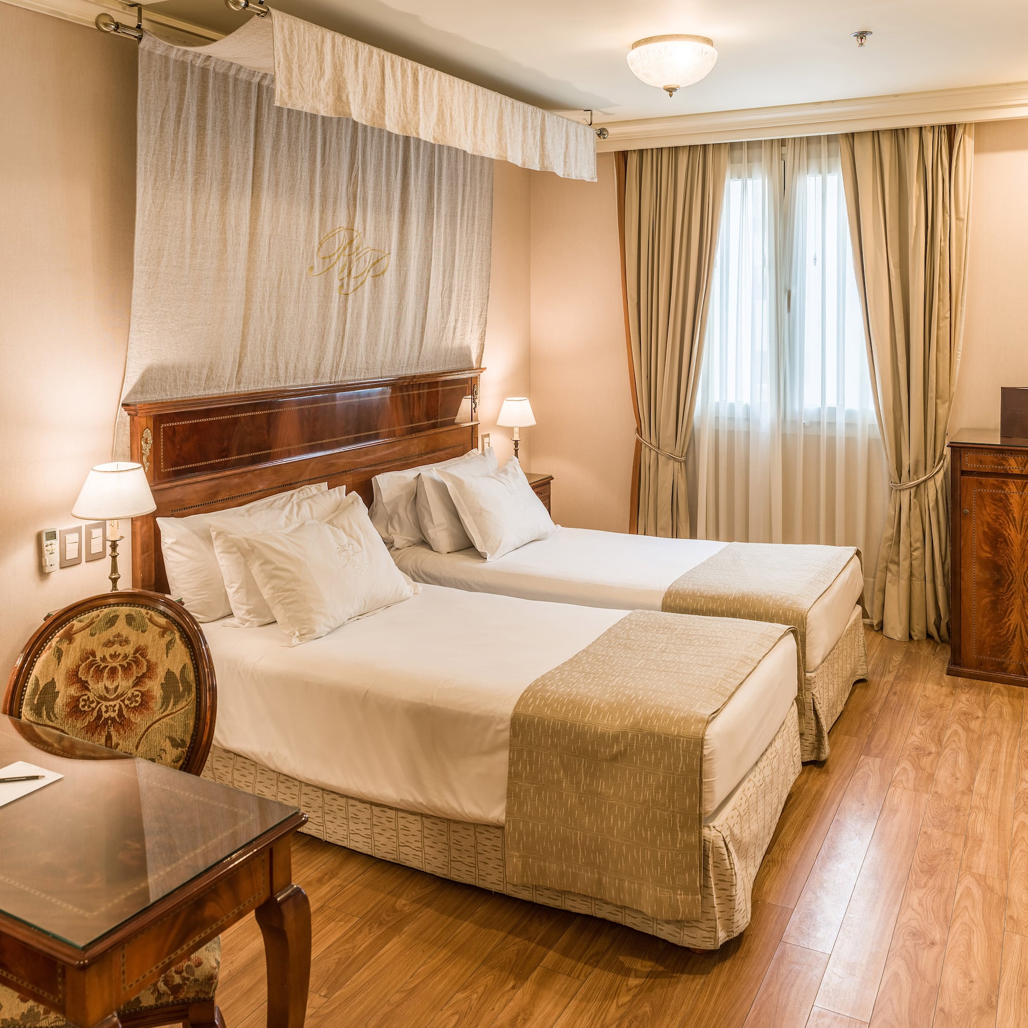 a room with two beds and a table