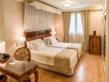 a room with two beds and a table