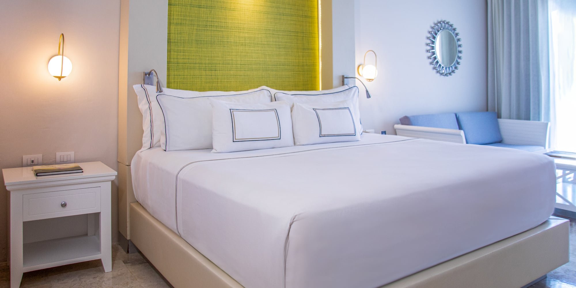 a bed with white sheets and pillows