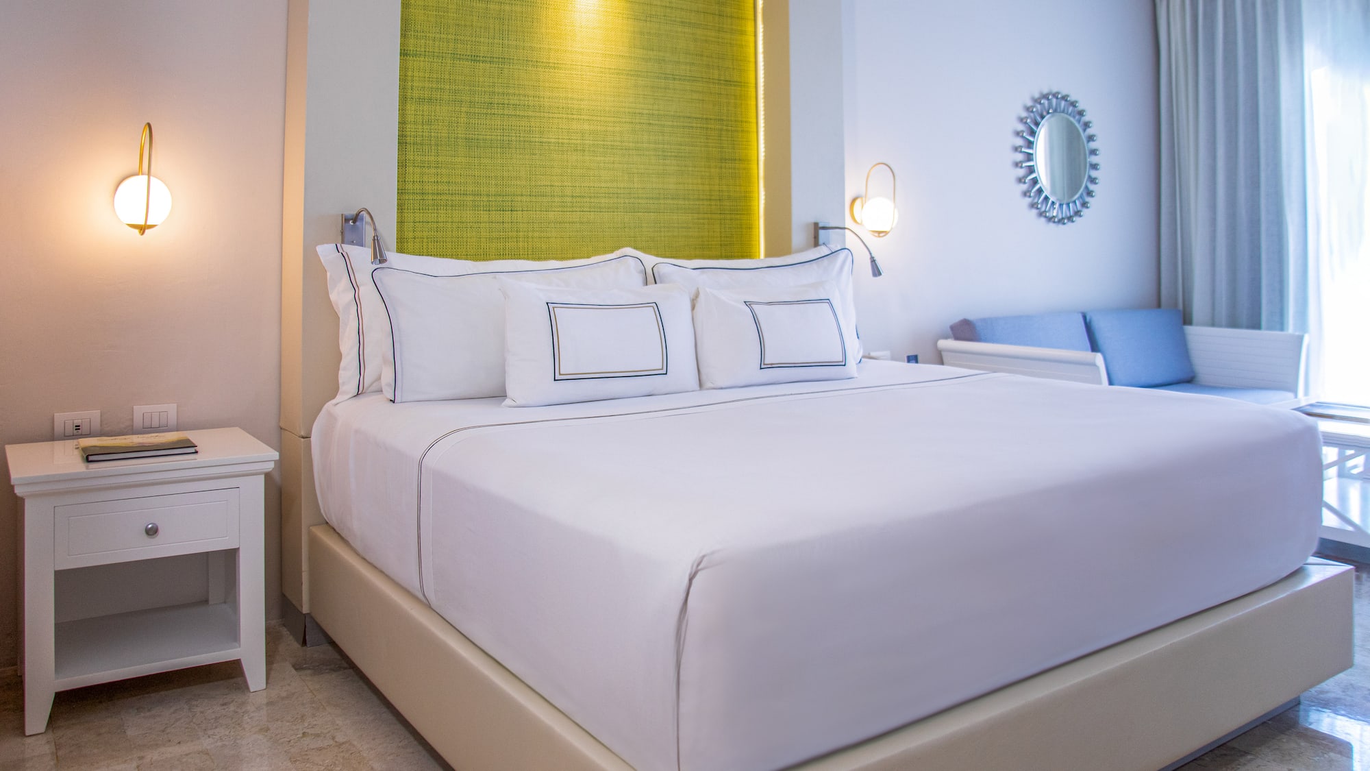 a bed with white sheets and pillows