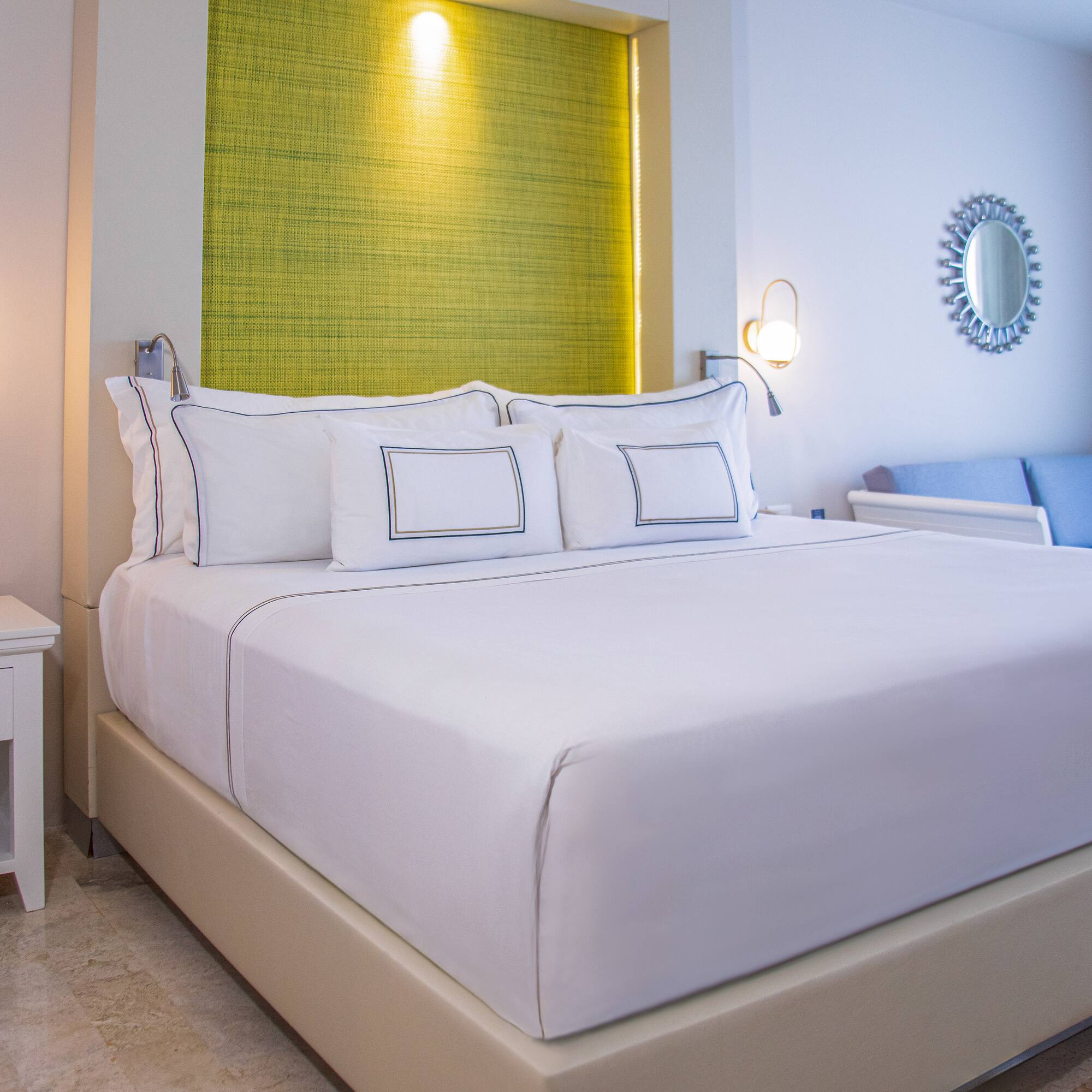 a bed with white sheets and pillows