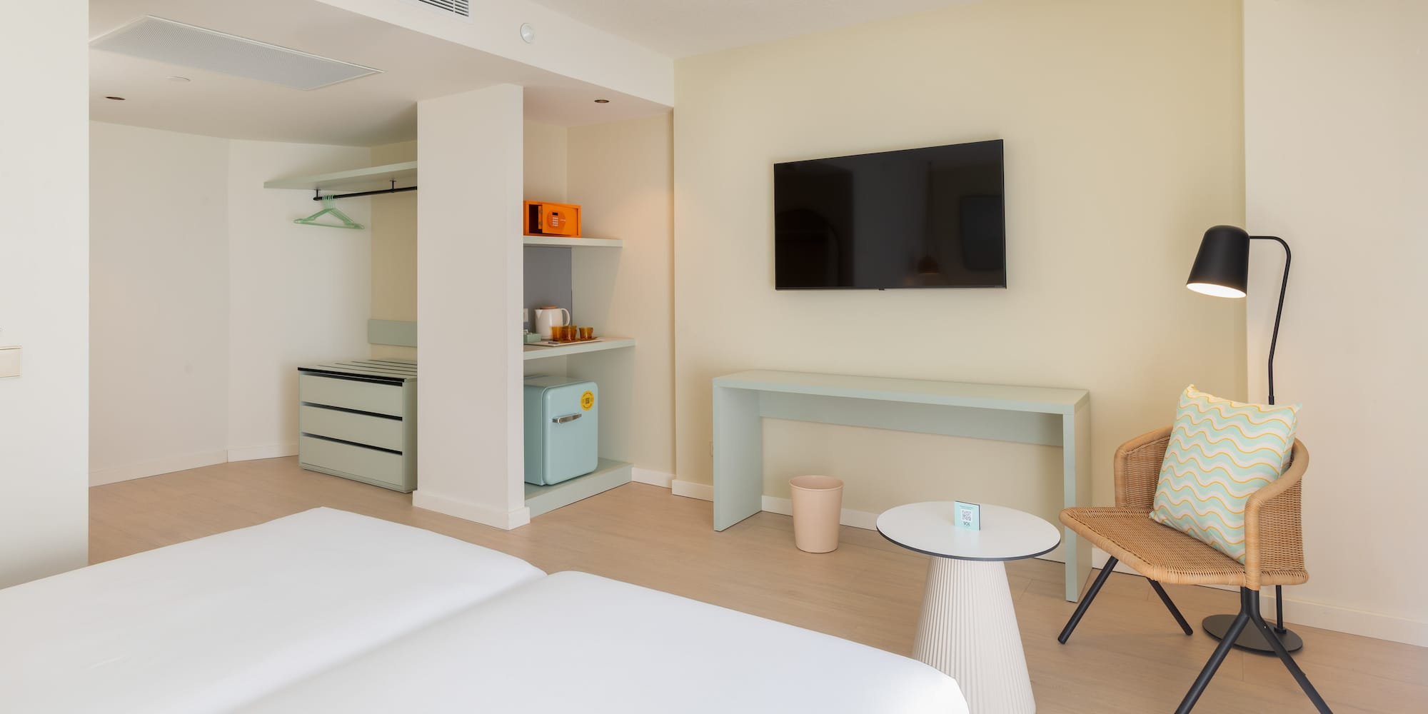 a room with two beds and a television