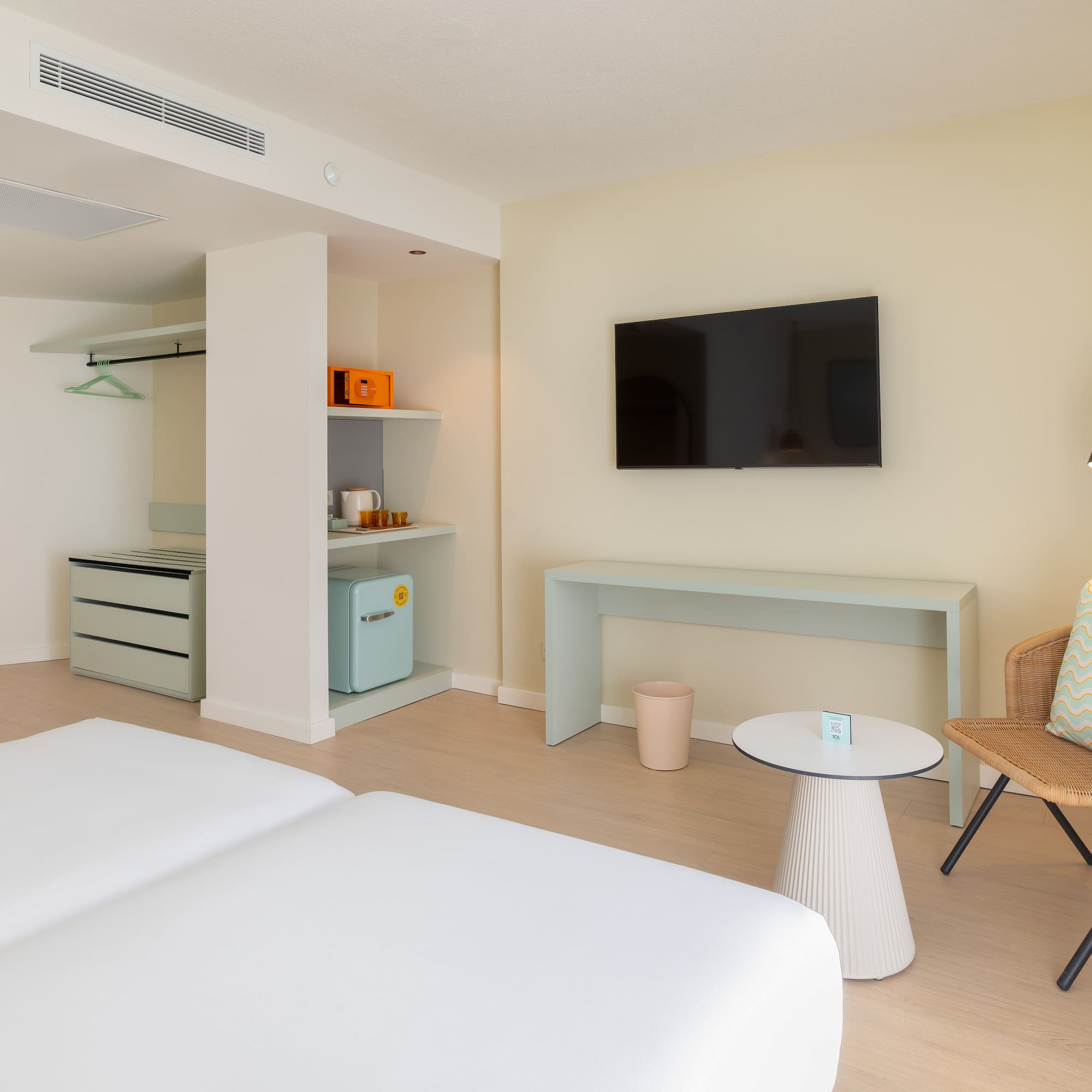 a room with two beds and a television