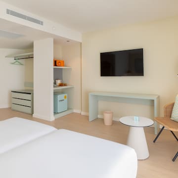 a room with two beds and a television