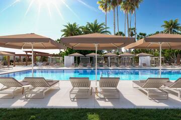 a pool with lounge chairs and umbrellas