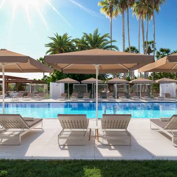 a pool with lounge chairs and umbrellas
