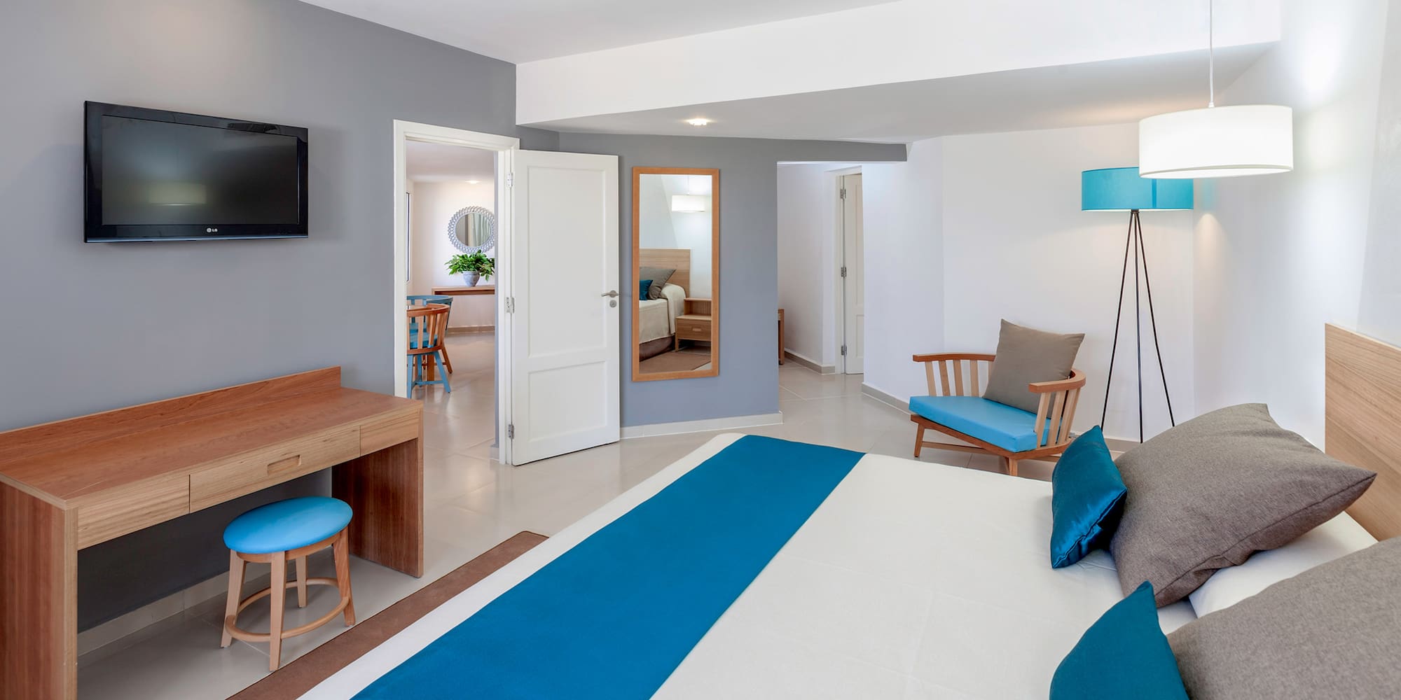 a bedroom with a bed and a television