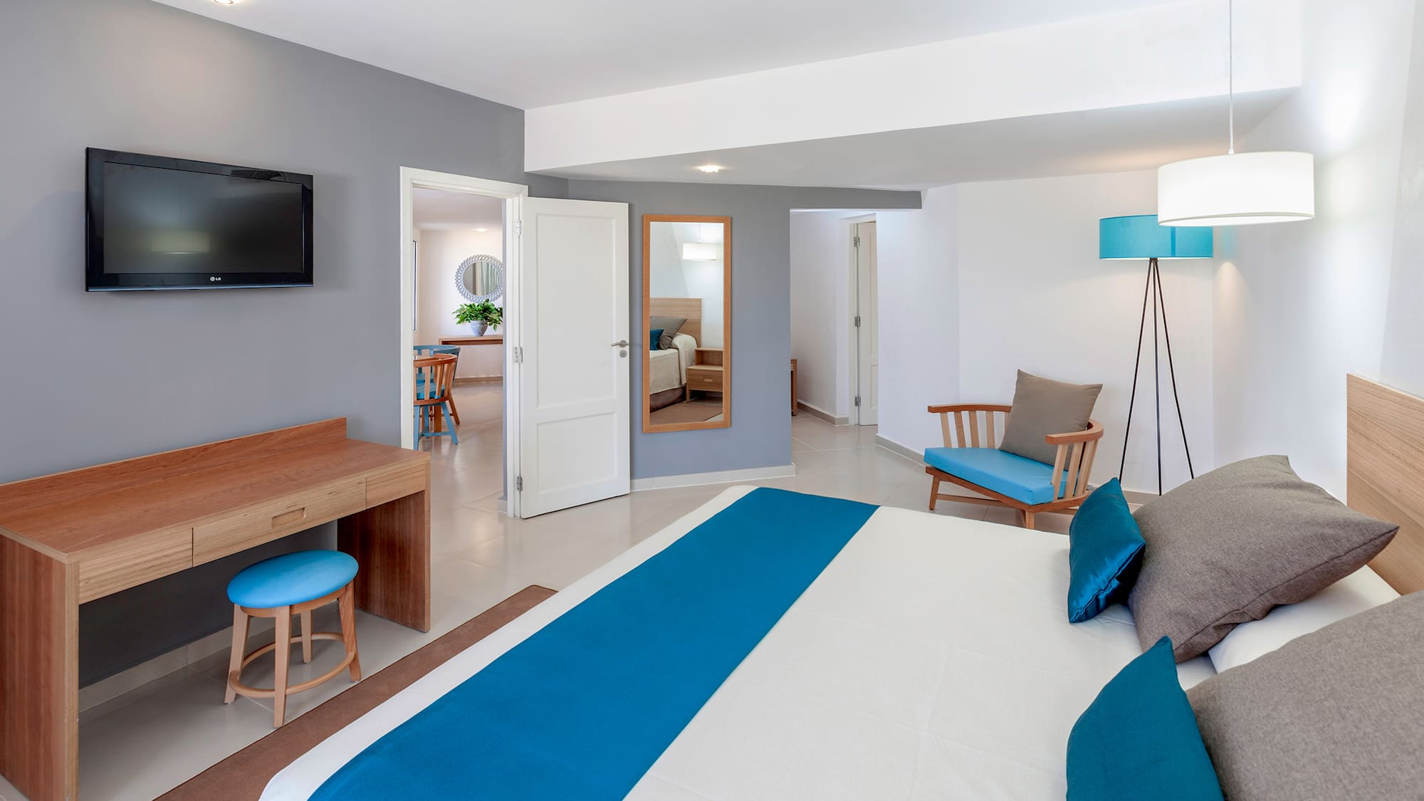 a bedroom with a bed and a television