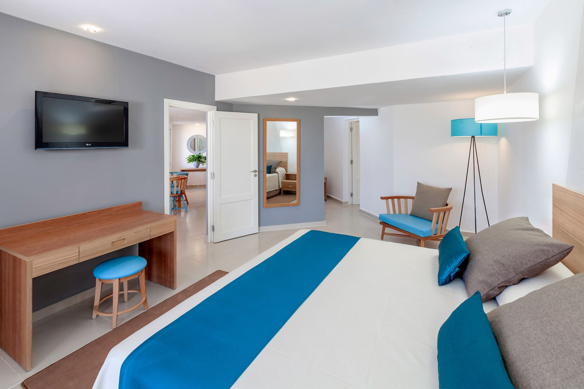 a bedroom with a bed and a television