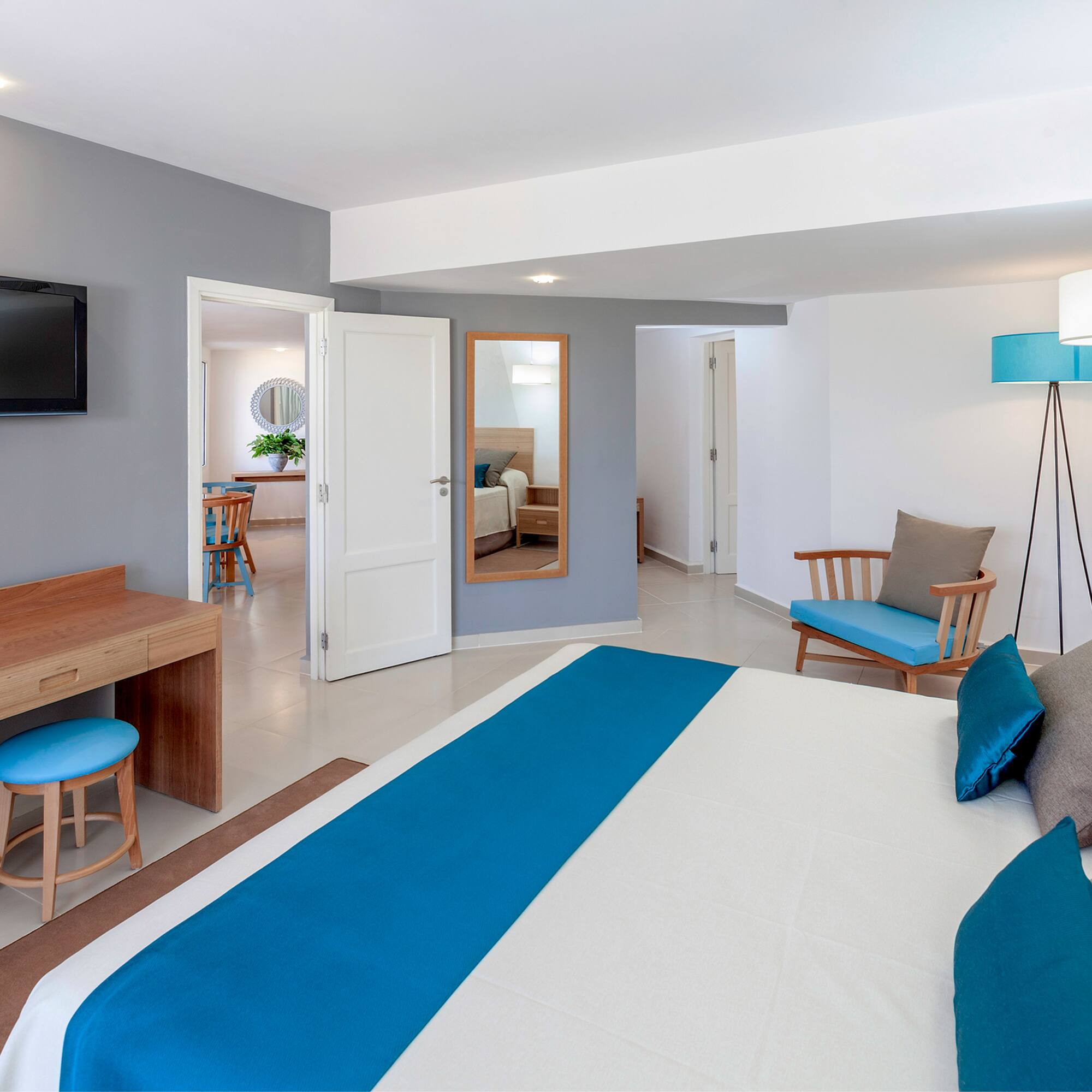 a bedroom with a bed and a television