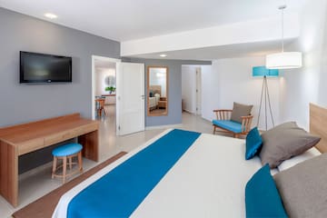 a bedroom with a bed and a television