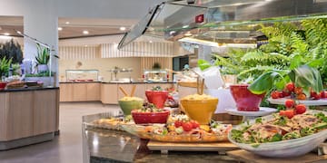 a buffet table with food in bowls