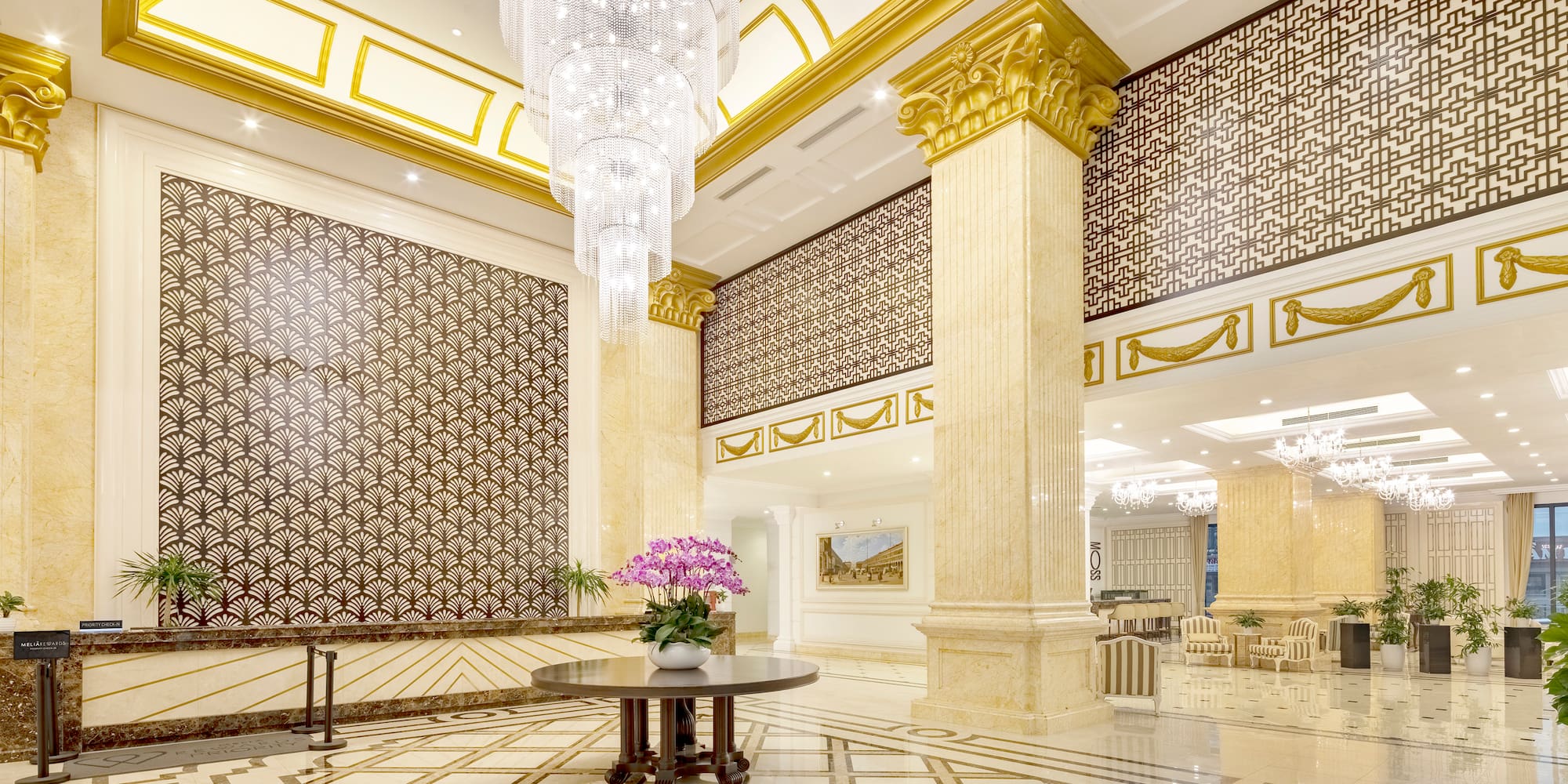 a large room with a chandelier and flowers
