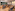Modern meeting room, classroom setup, wood tables, dark chairs, green wall.