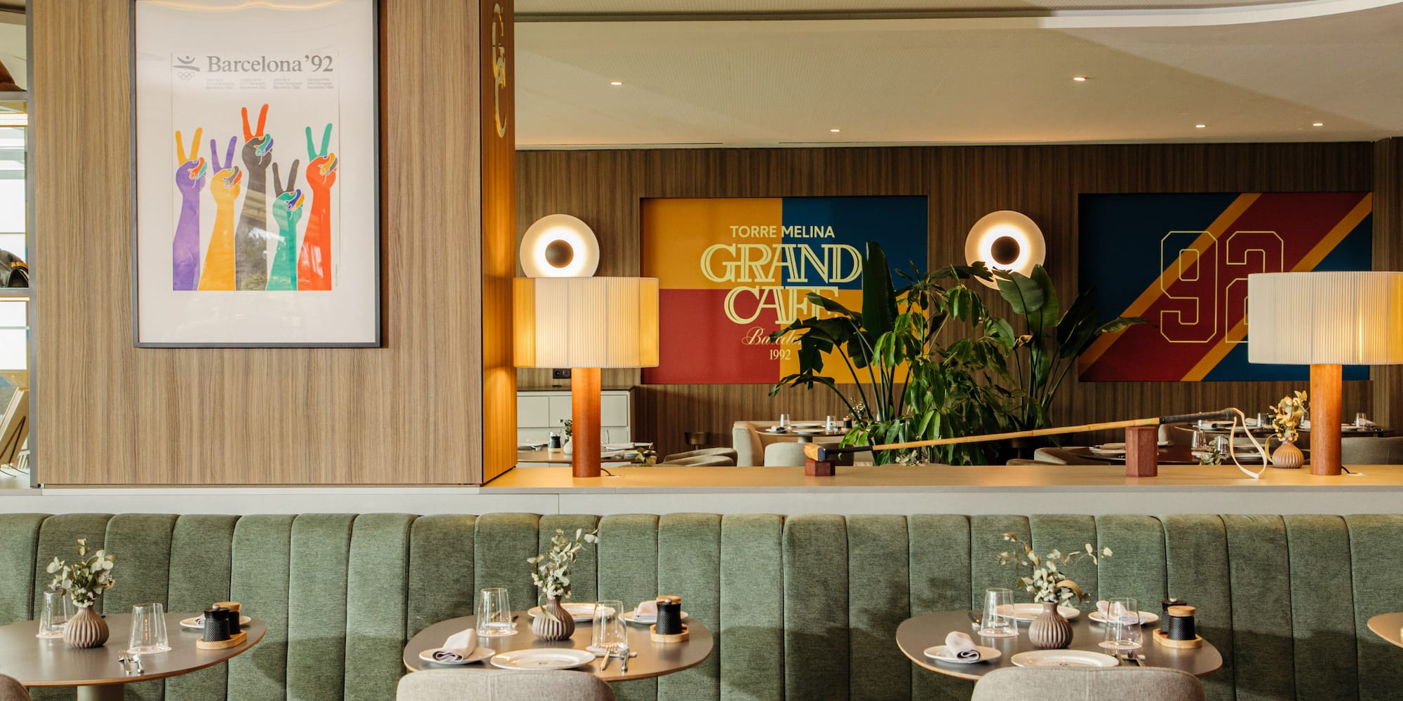 a restaurant with green booth seating and green couches