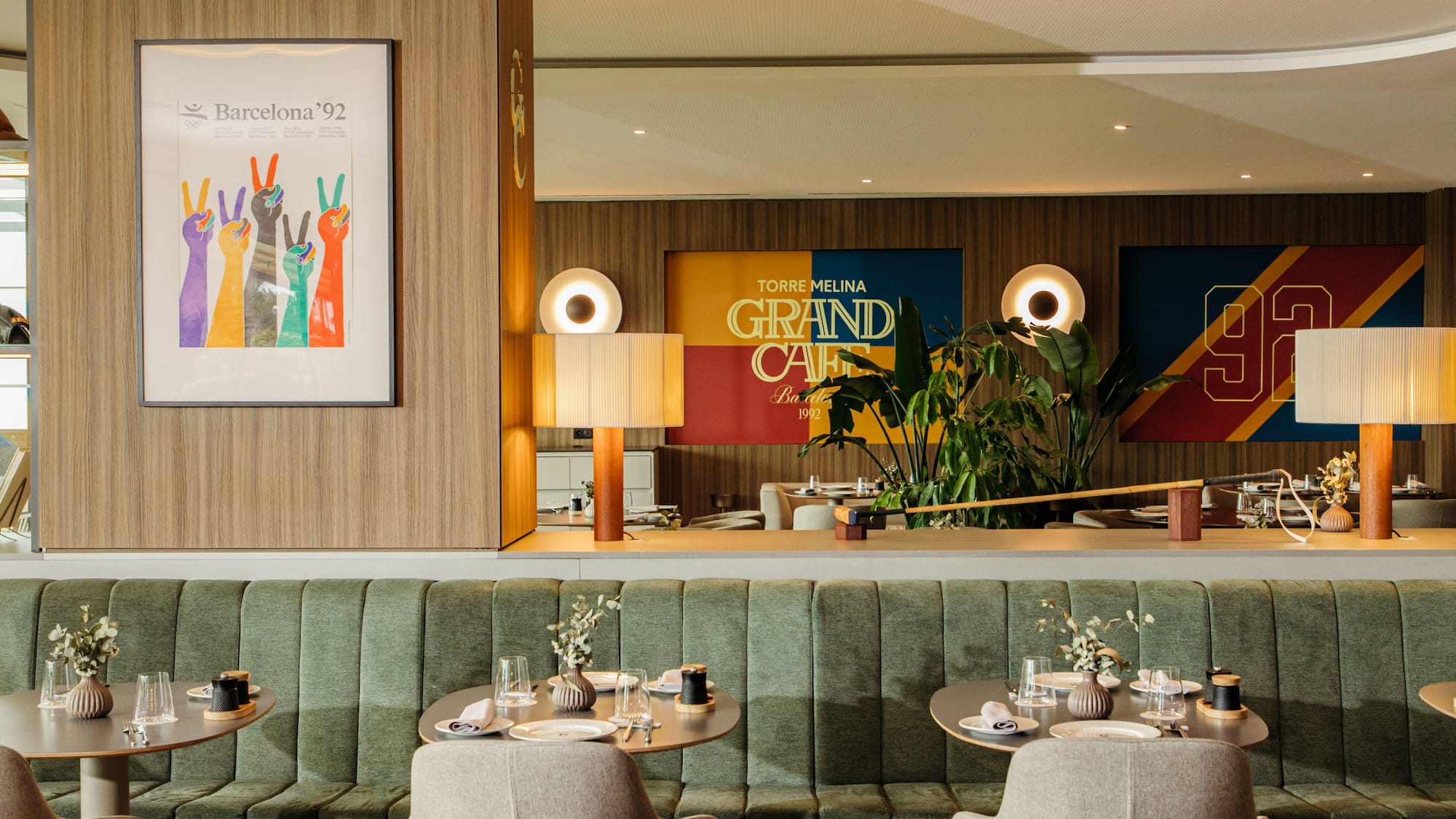 a restaurant with green booth seating and green couches