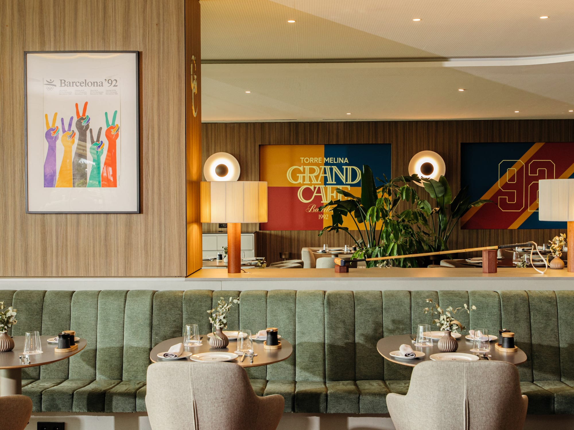 a restaurant with green booth seating and green couches