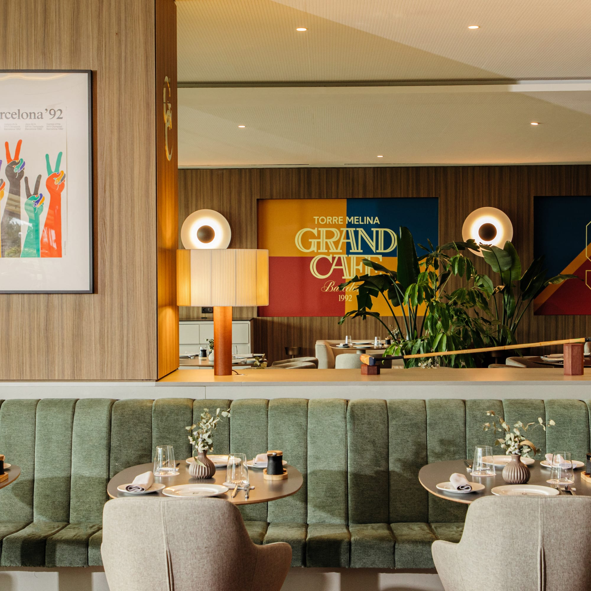 a restaurant with green booth seating and green couches