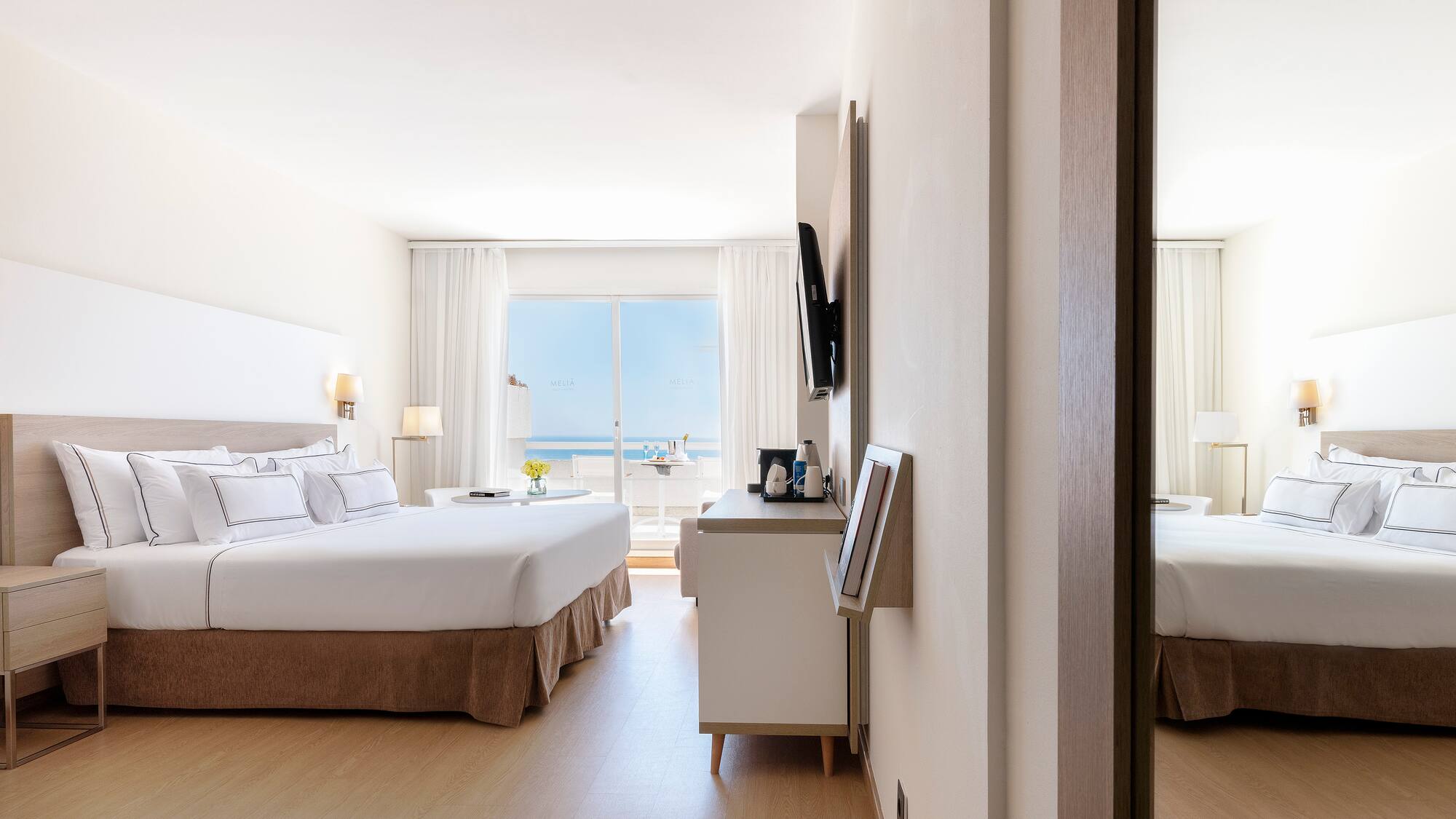 a room with a bed and a mirror