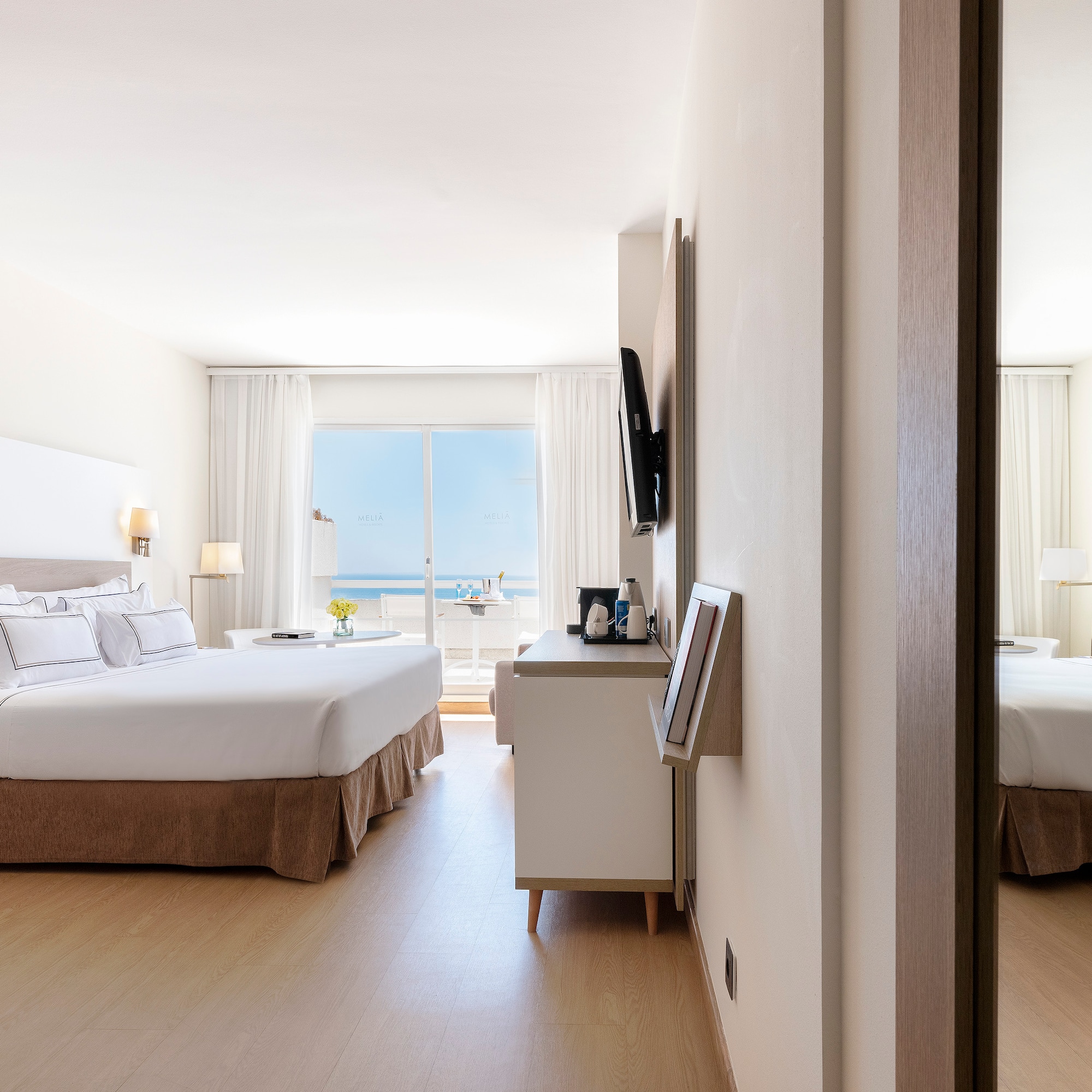 a room with a bed and a mirror