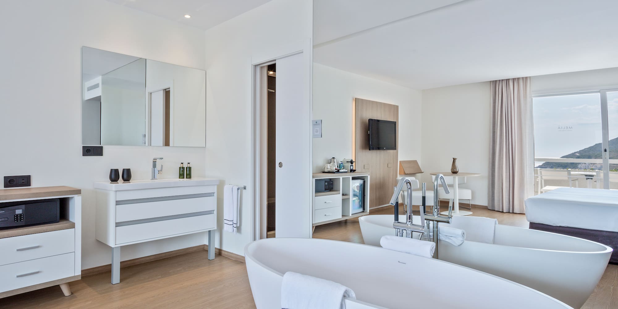 a bathroom with a large tub and a mirror
