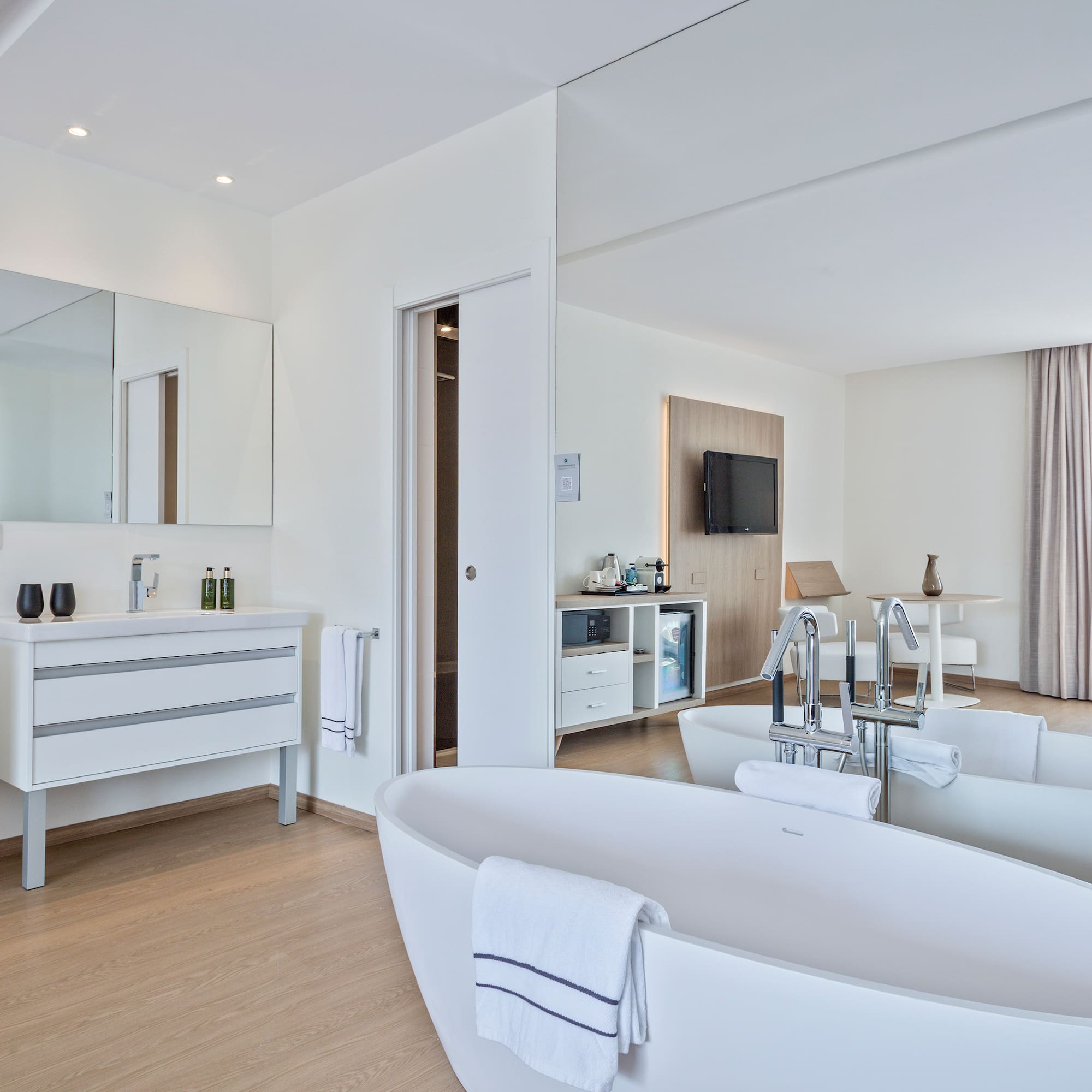 a bathroom with a large tub and a mirror
