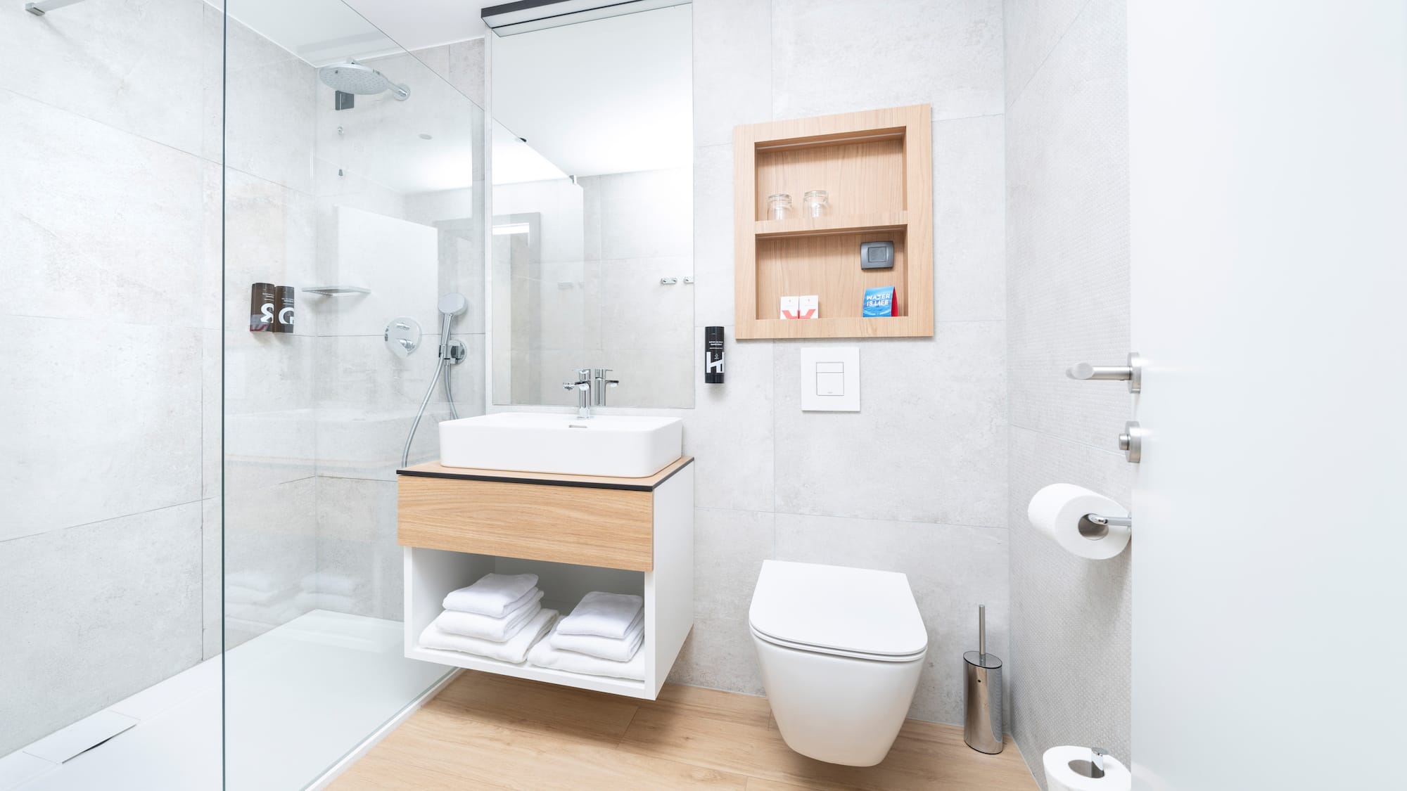 a bathroom with a glass shower and a sink